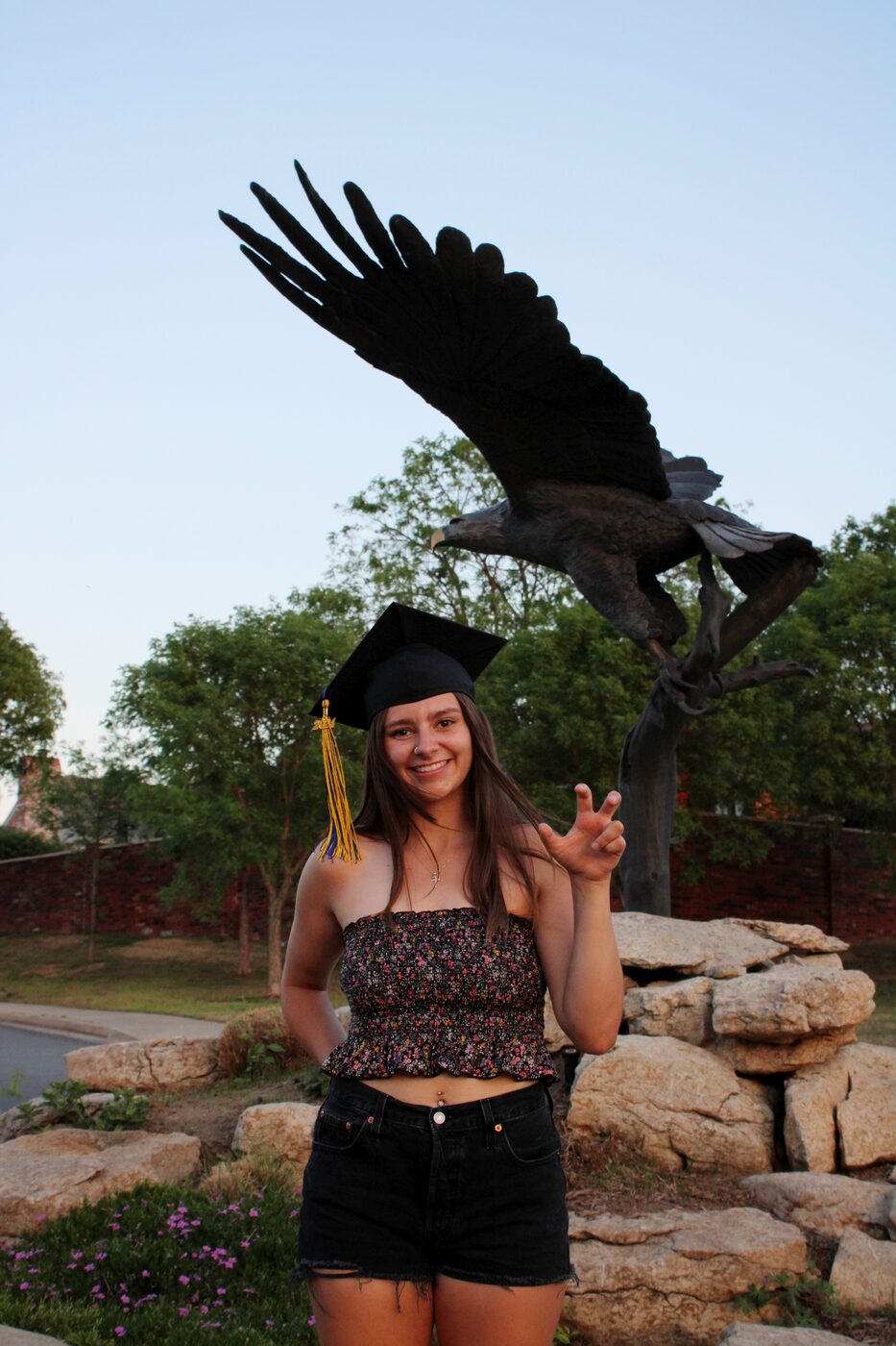 Senior portrait beneath a bronze eagle statue