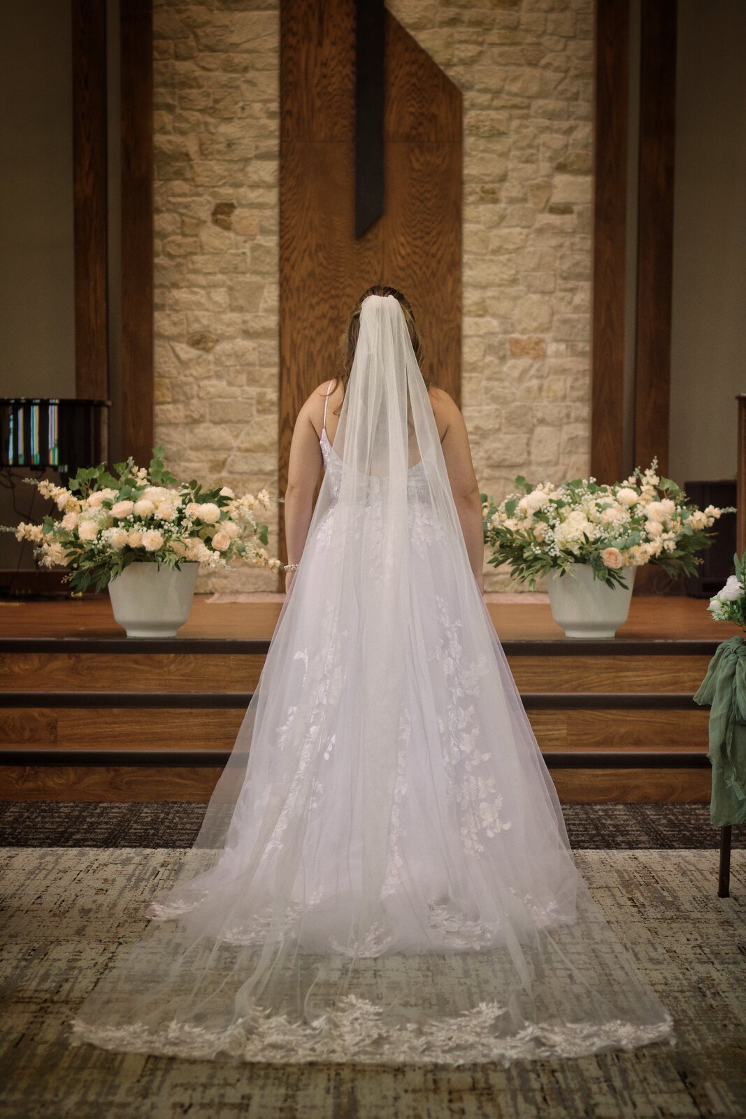 Bride at the altar, veil catching light